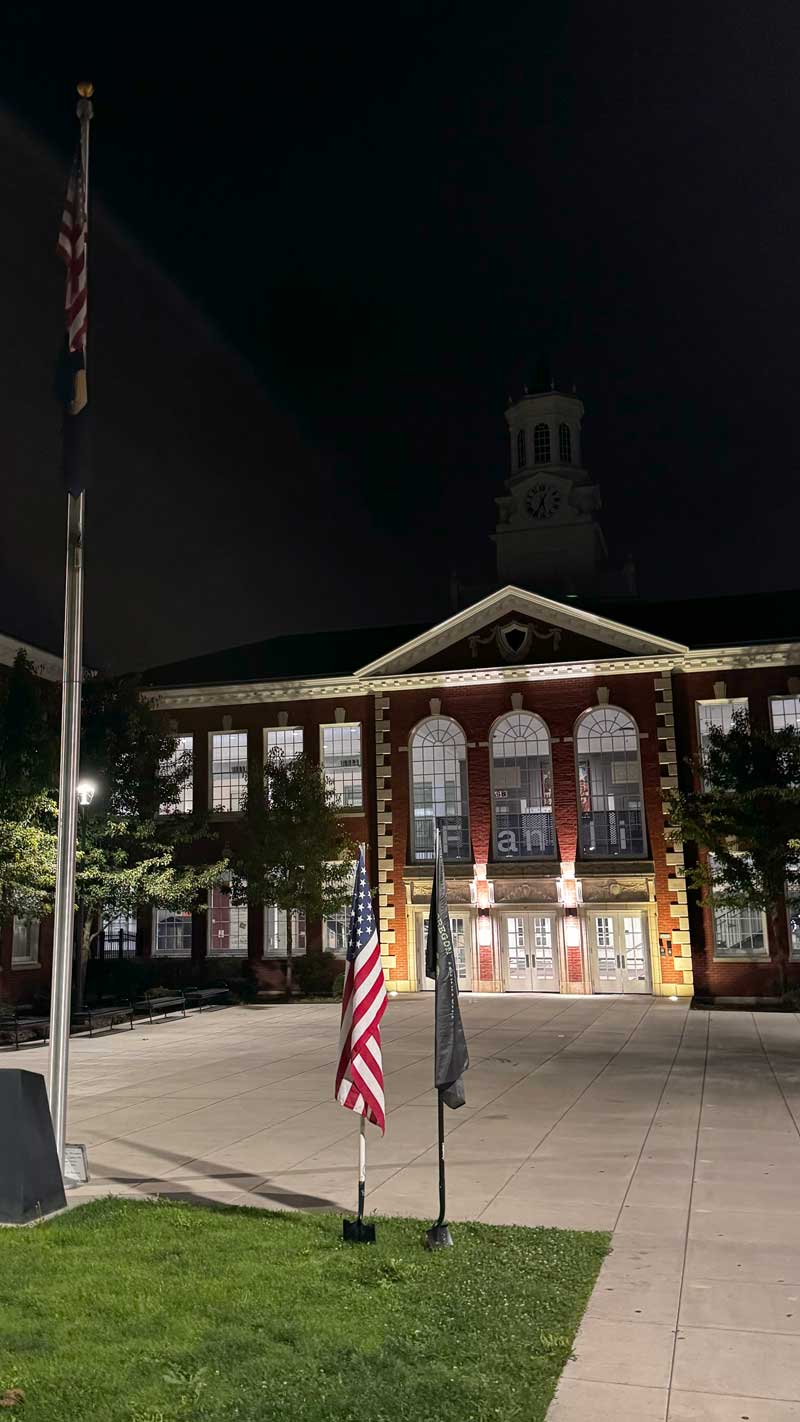 Picture of the meeting place for the Lightning Rod AO at the entrance to Franklin high school. Two shovel flags are in the foreground.